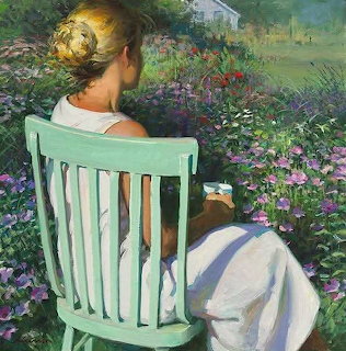 Woman seated on green chair viewing colorful garden flowers