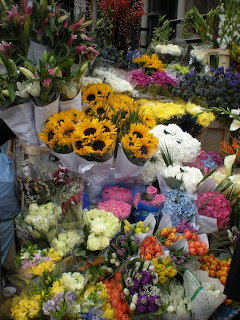 Colorful flower bouquets displayed together at a market stall