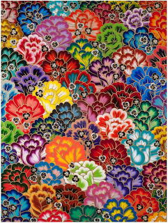 Densely packed colorful painted flowers in various bright hues covering the entire image