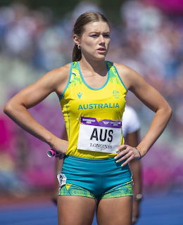 Female athlete in yellow and green Australia uniform at a track and field competition