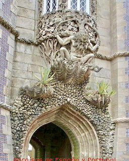 Elaborate stone portal with mythological figures and shell decorations on a Gothic palace facade
