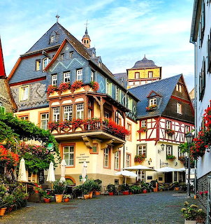 Traditional half-timbered buildings with flower boxes in a German village plaza