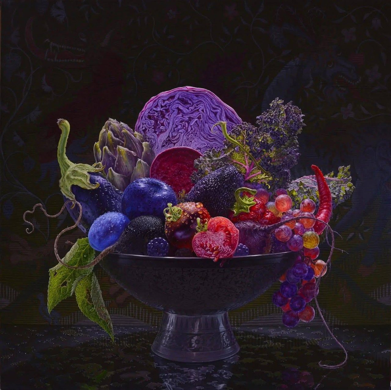 Still life painting of fruit and vegetables in a dark pedestal bowl against a black background