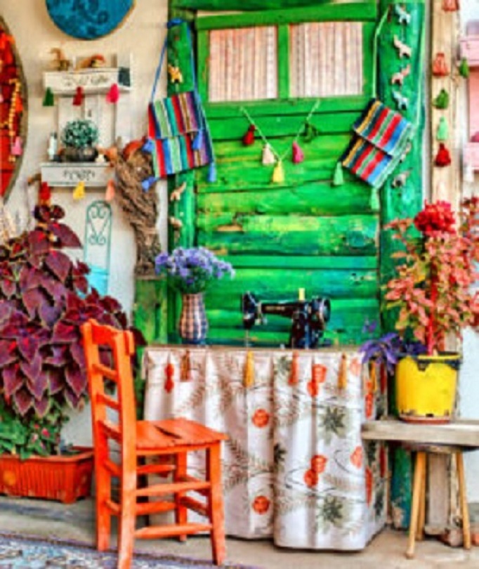 Colorful rustic sewing corner with green window, orange chair, sewing machine, and plants