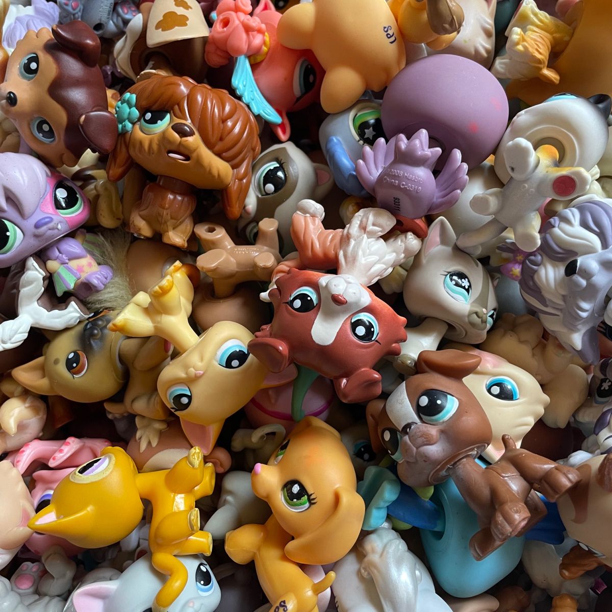 Close-up of a pile of colorful Littlest Pet Shop animal toy figures