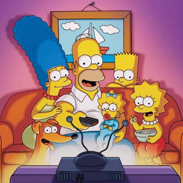 The Simpsons family sitting on their orange couch watching TV together