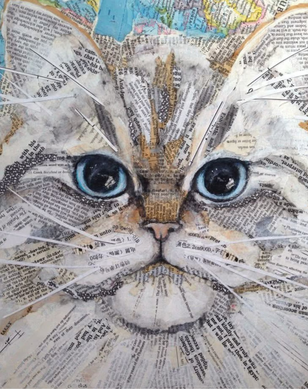 Cat face made from torn newspaper and map paper collage with blue eyes and white whiskers
