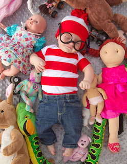 Baby in Waldo Costume with Toys
