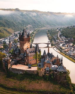 Cochem Castle on a hill above the Moselle River and village in Germany