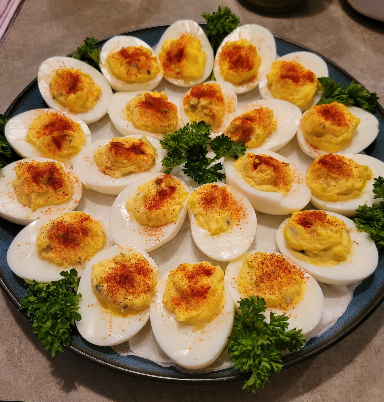 Plate of deviled eggs garnished with parsley