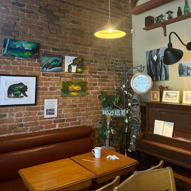 Cozy cafe interior with brick walls, wooden booths, hanging lamp, and vintage clock