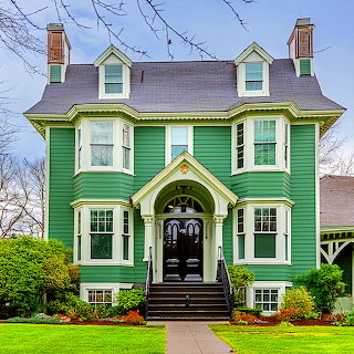 Green Victorian House with Bay Windows