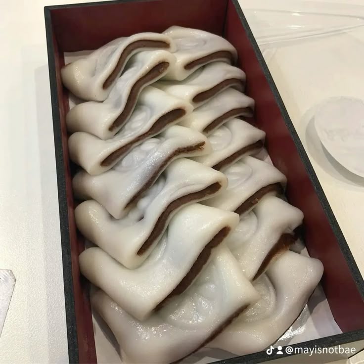 White red bean mochi arranged in a rectangular tray on a table