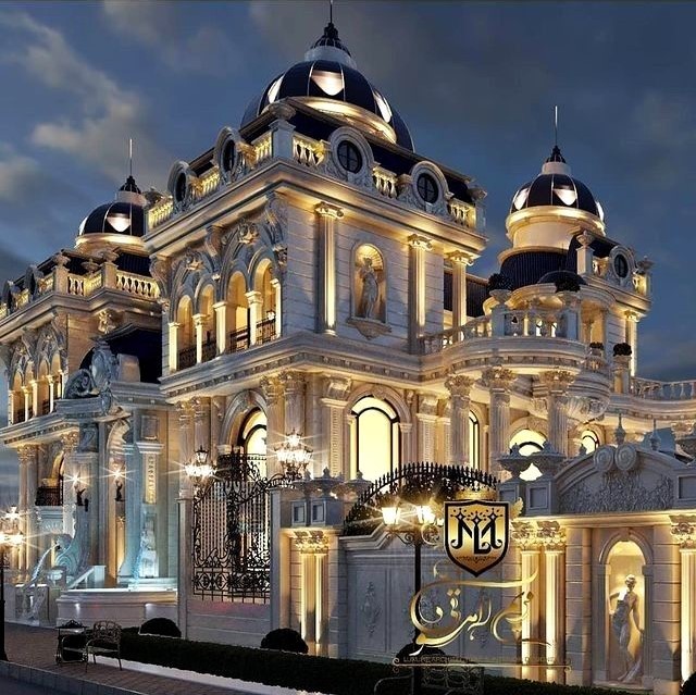Illuminated baroque palace with domed towers and classical columns at night