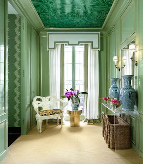 Elegant room with ornate green malachite ceiling, white furniture, tall windows, and decorative accents