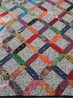 Colorful patchwork quilt with geometric patterns and varied fabric squares
