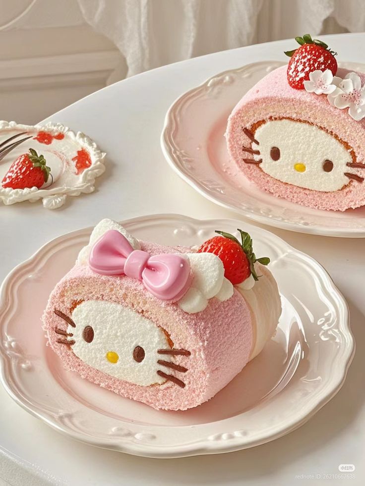 Pink Hello Kitty cake rolls with strawberries and whipped cream on white plates