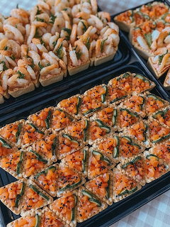 Close-up of assorted savory canapes and appetizers on black serving trays