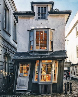 Leaning historic house with bay windows on a narrow street in Windsor, England