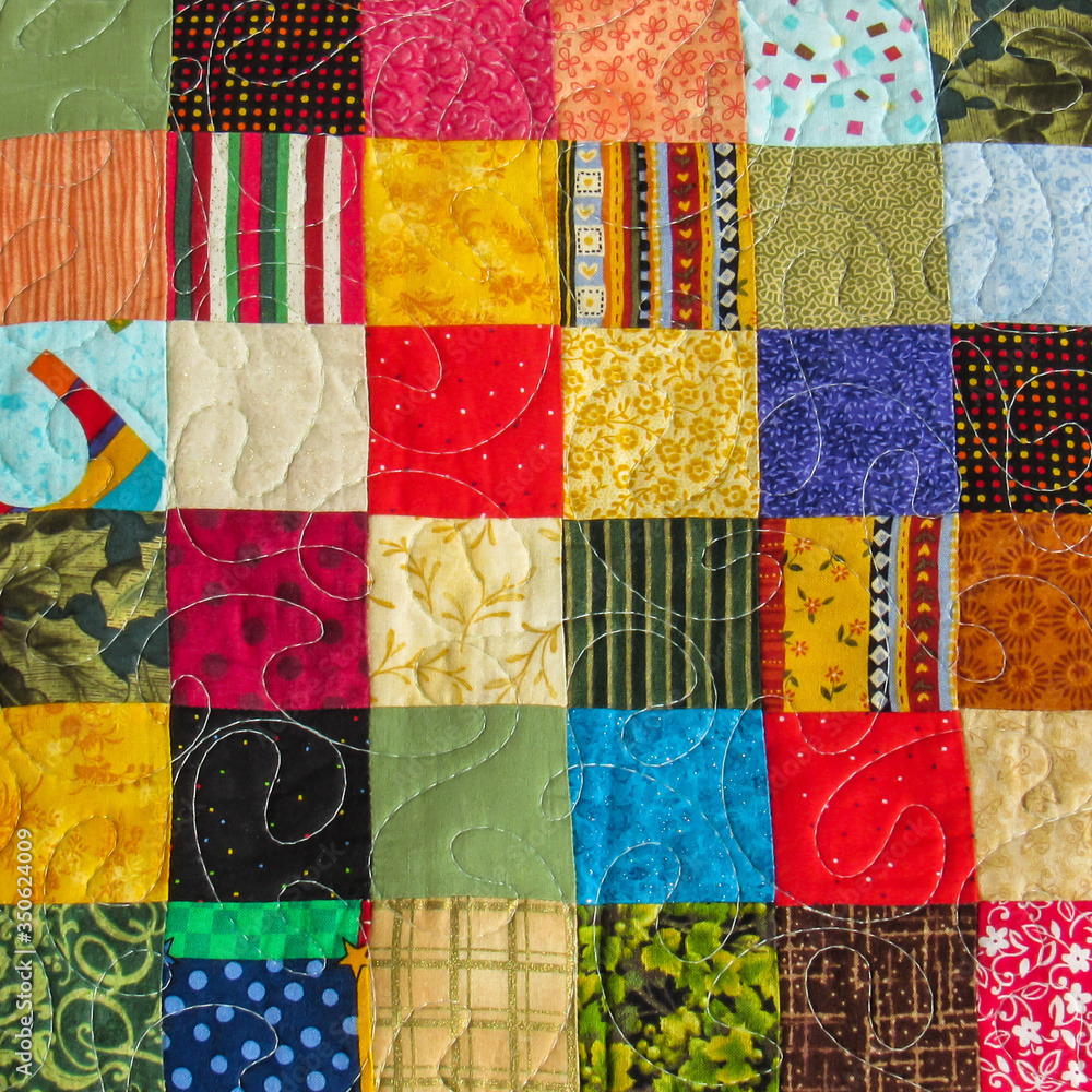 Colorful patchwork quilt grid with 49 fabric squares in varied patterns including florals, stripes, dots and geometrics