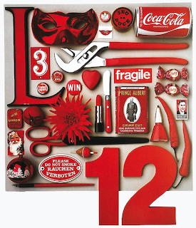 Collage of assorted red objects including scissors, numbers, packaging, tools, and decorative items