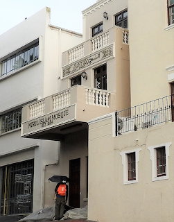 Beige mosque building facade with decorative balconies and arched entrance in Cape Town