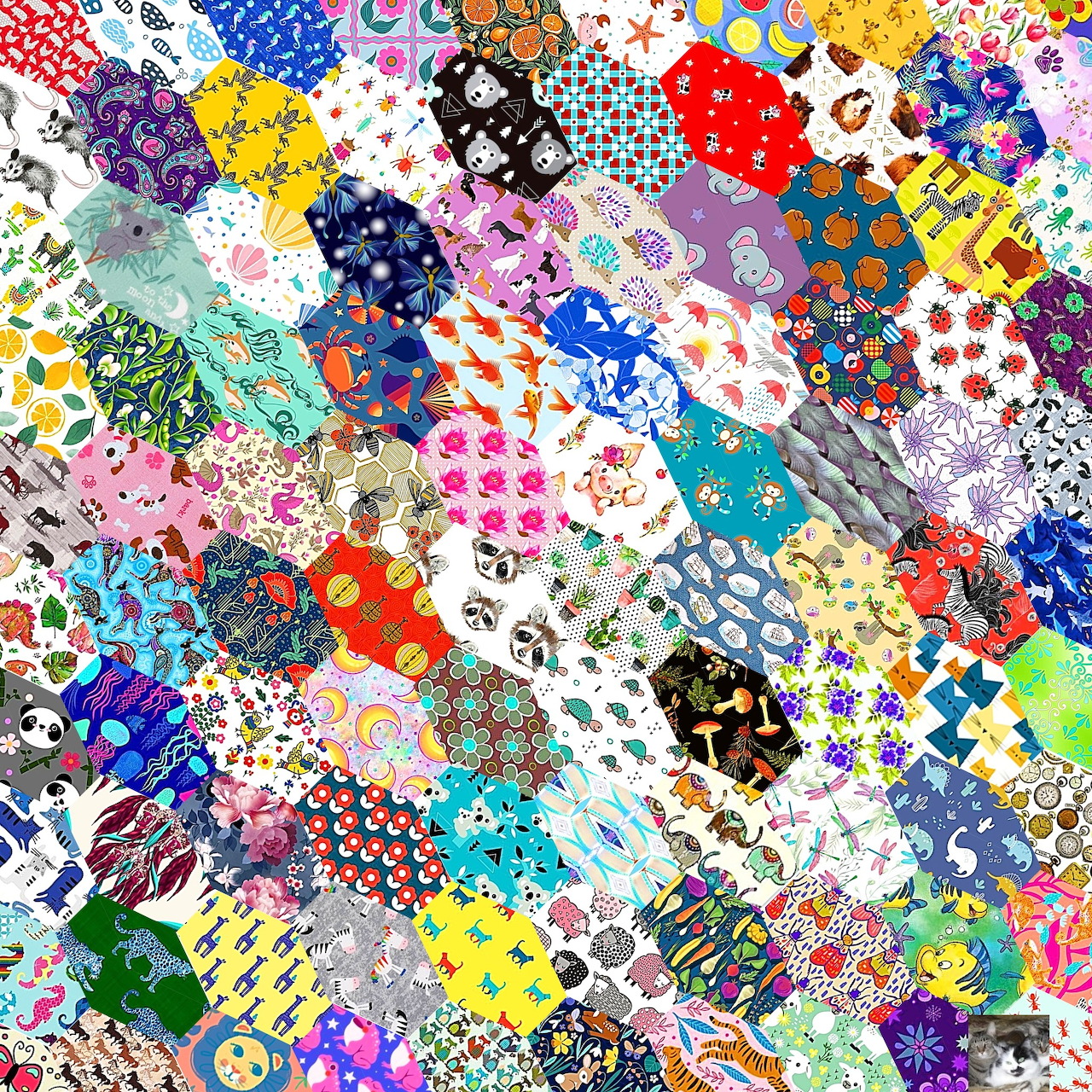 Colorful patchwork quilt with varied fabric patterns including flowers, dots, and geometric designs