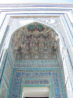 Ornate Islamic entrance with turquoise tiles and honeycomb dome ceiling