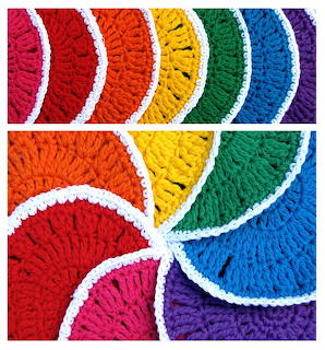Vibrant rainbow-colored crochet bunting flags with white scalloped edges arranged in decorative pattern