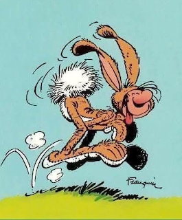Cartoon character Gaston Lagaffe wearing a brown rabbit costume hopping on grass against teal background