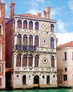 Ca' Dario palace facade on the Grand Canal in Venice with ornate marble decorations and arched windows