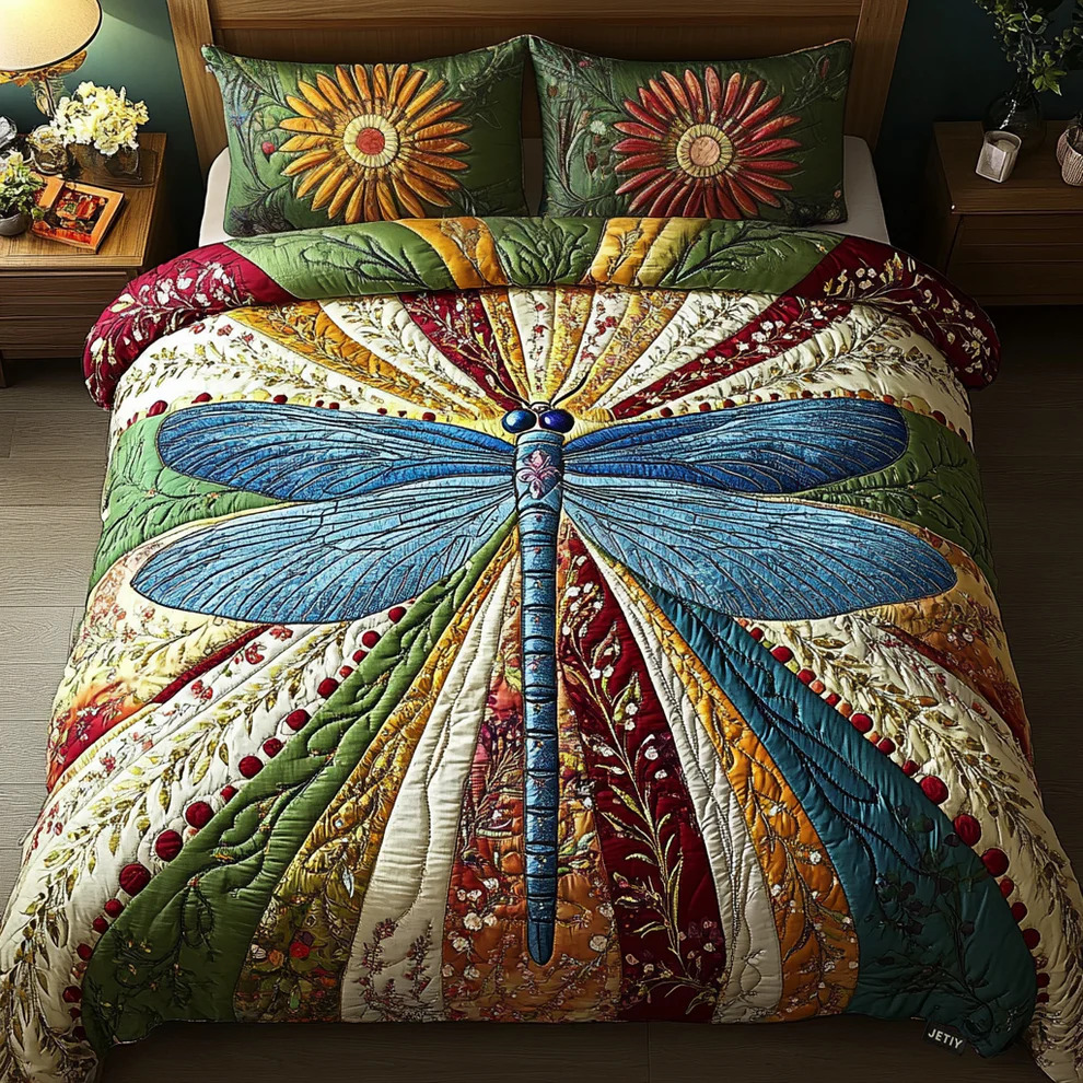 Patchwork quilt with dragonfly design on bed with decorative pillows