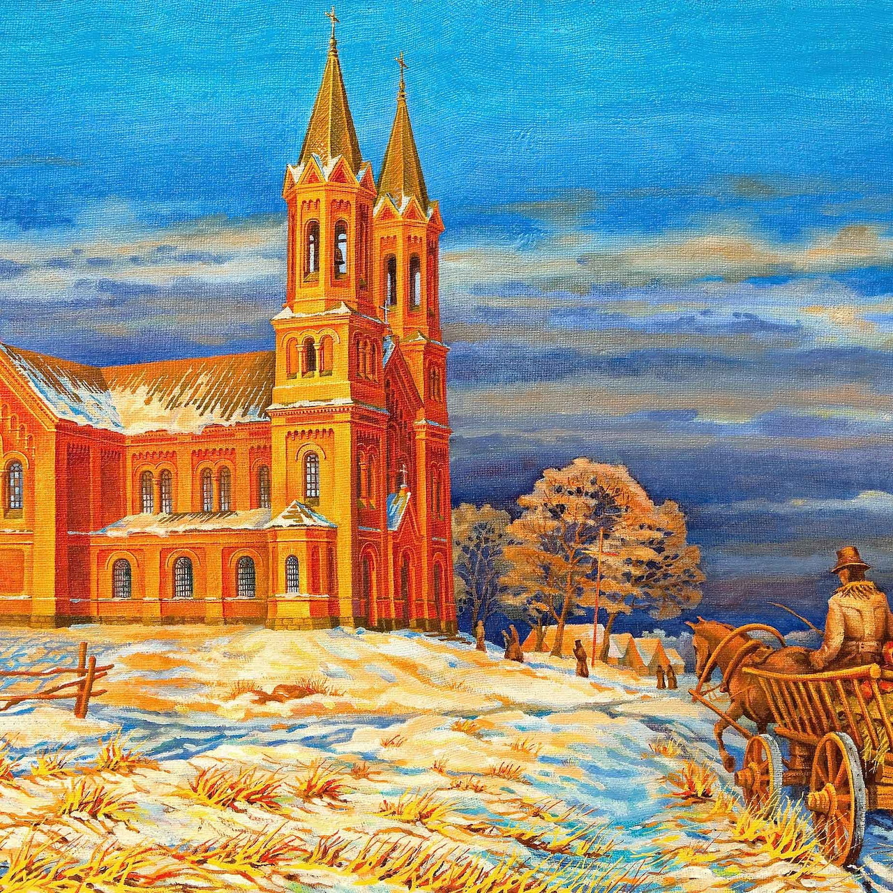 Orange church with two spires in snowy winter landscape at dusk with golden trees