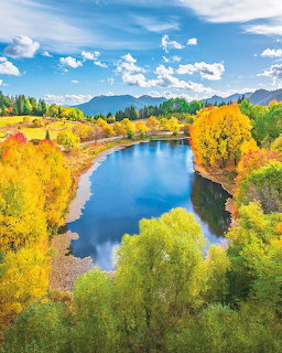 Aerial view of lake with fall foliage and mountains
