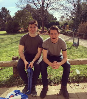 Two Men Sitting on Bench in Park