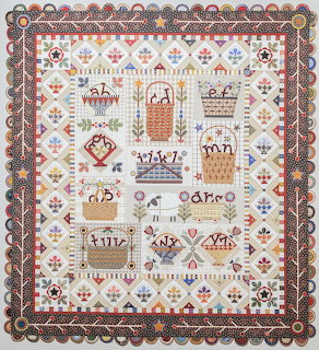 Folk art sampler with baskets, birds, flowers in traditional needlework style with ornate decorative border