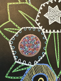 Abstract drawing with green leaves, white borders, and a circular mandala filled with multicolored dots on black paper