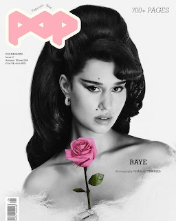 Black-and-white portrait of a woman holding a pink rose on a magazine-style cover