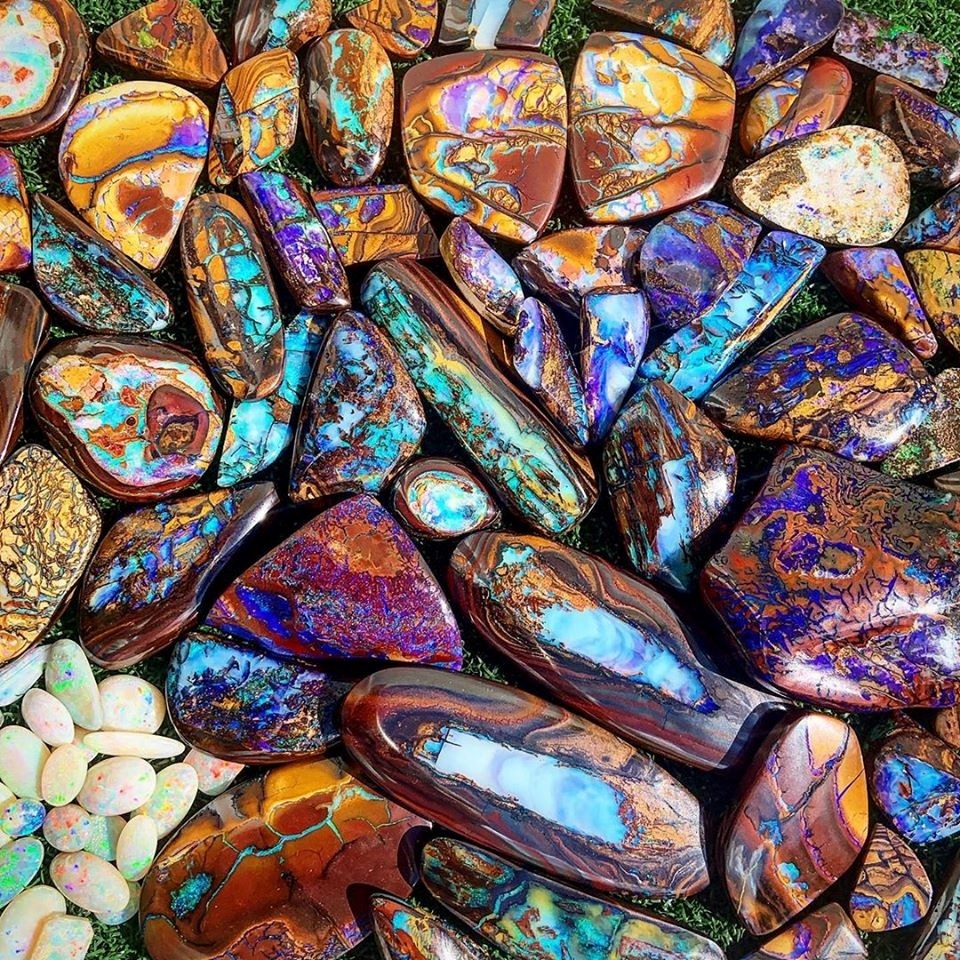 Close-up of polished boulder opals with iridescent blue, purple, and orange patterns