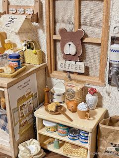 Rustic kitchen coffee corner with shelves, mugs, jars, and coffee-themed decor