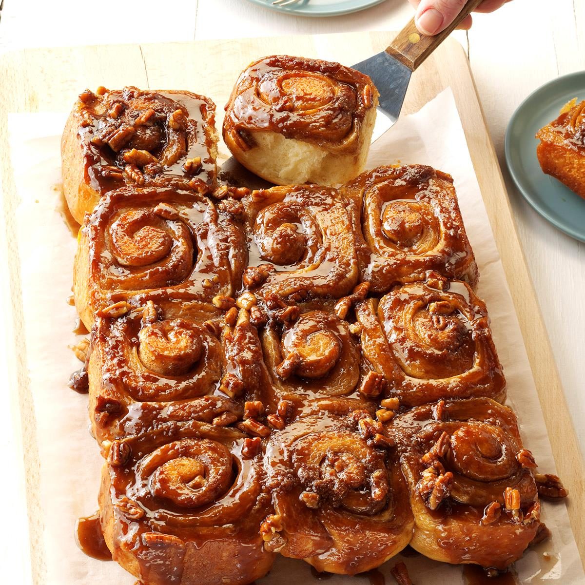 Tray of golden caramel pecan rolls with nuts and sauce