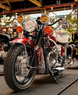 Red vintage Moto Guzzi California motorcycle with chrome details on display stand