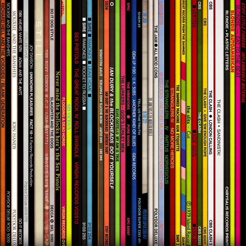 Colorful spines of vinyl record albums arranged vertically on a shelf