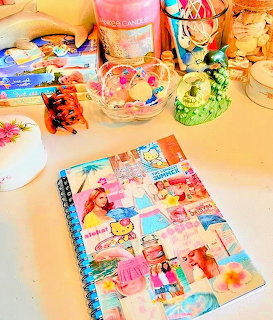 Colorful scrapbook with tropical collage, seashells, and craft supplies on desk