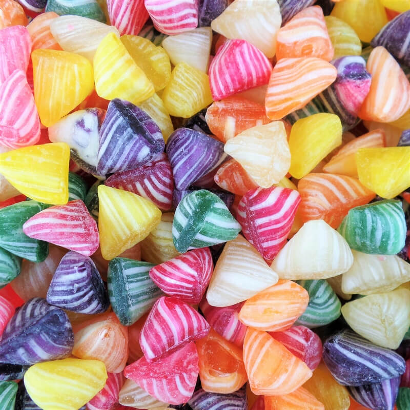 Colorful striped hard candies in various colors arranged in a pile