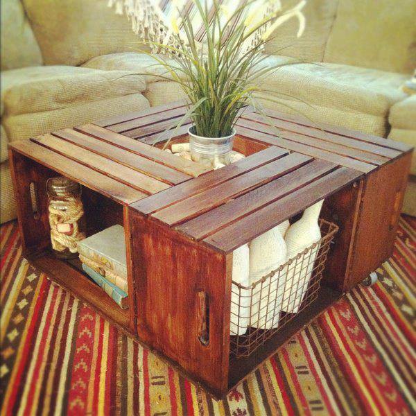 Rustic wooden crate coffee table with a potted plant on a striped rug in a living room