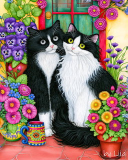 Two tuxedo cats surrounded by colorful flowers and plants near a turquoise window