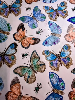 Colorful hand-drawn butterflies and insects illustration with blue, orange, and teal species on light background