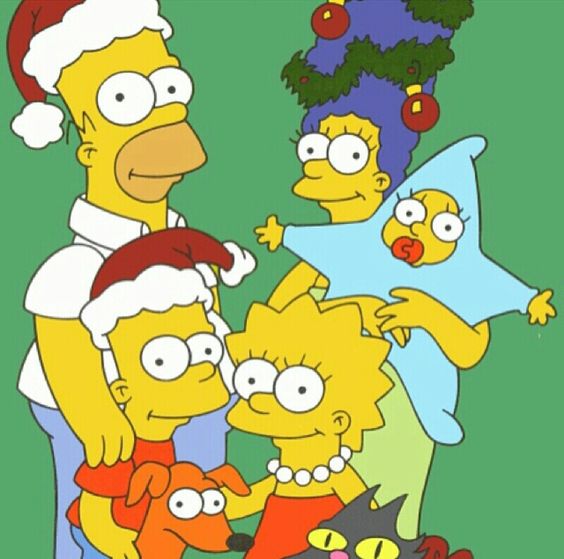 The Simpsons family in Santa hats beside a Christmas tree, with Maggie in a blue star costume.