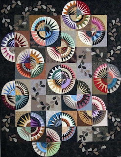 Abstract patchwork of colorful spiral fan patterns on a dark background with leaf motifs